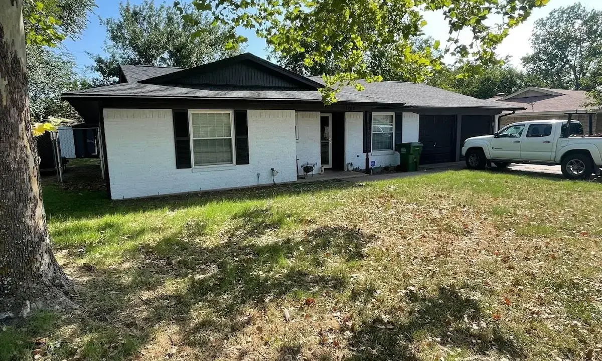 Professional roofing crew working on a residential roof in Mont Belvieu